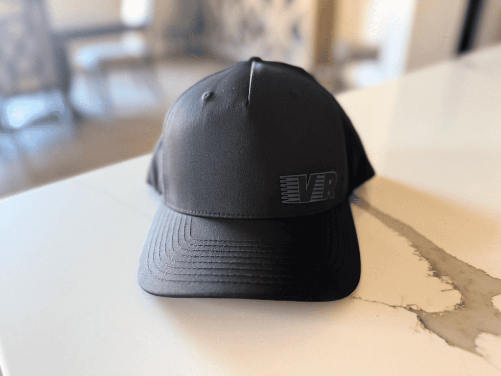 Black cap with VR logo on a table.